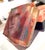 This artwork features a hauntingly expressive face, rendered with a delicate interplay of layered resin, pastel, and...