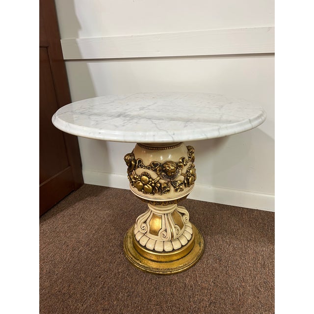 A pair of signed 1966 Fugitti Studios Column style cherub marble top side tables. Beautiful design in Hollywood Regency...