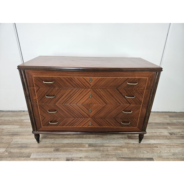 An elegant and timeless 1980s Italian dresser with four spacious drawers. Made of fine herringbone walnut, it is enhanced...