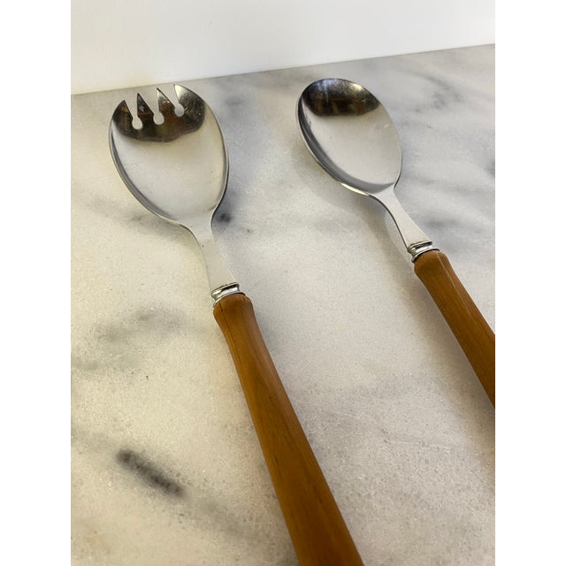Vintage English country set featuring two salad serving spoon and fork with elm wood handles. Marked "Sheffield England."