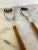 Vintage English country set featuring two salad serving spoon and fork with elm wood handles. Marked "Sheffield England."