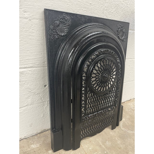 A remarkable piece of Southern architectural history, this late 19th-century cast iron fireplace surround and matching...