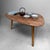 Vintage wooden coffee table, probably originating from Belgium. The table features an organically shaped top with soft,...
