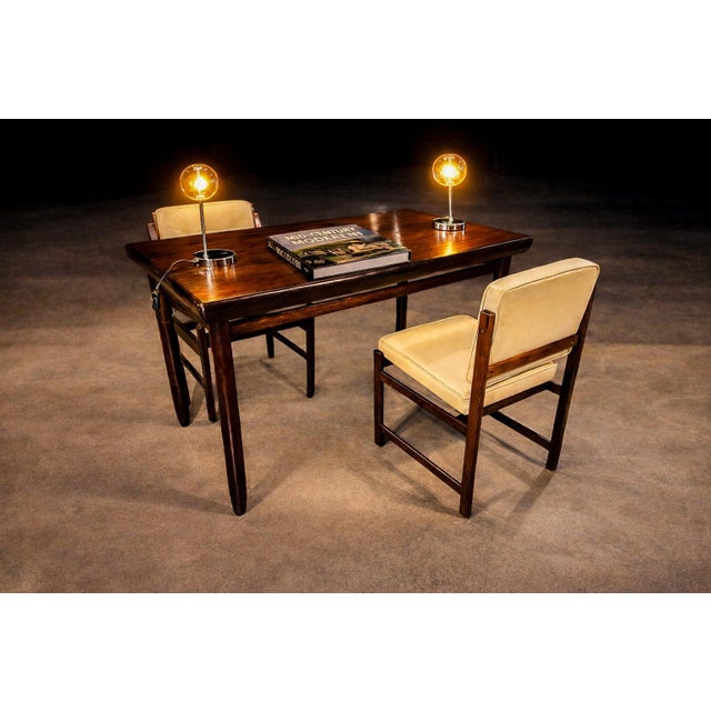 This pair of Brazilian mid-century lamps reflects the period’s engagement with industrial form and polished material....