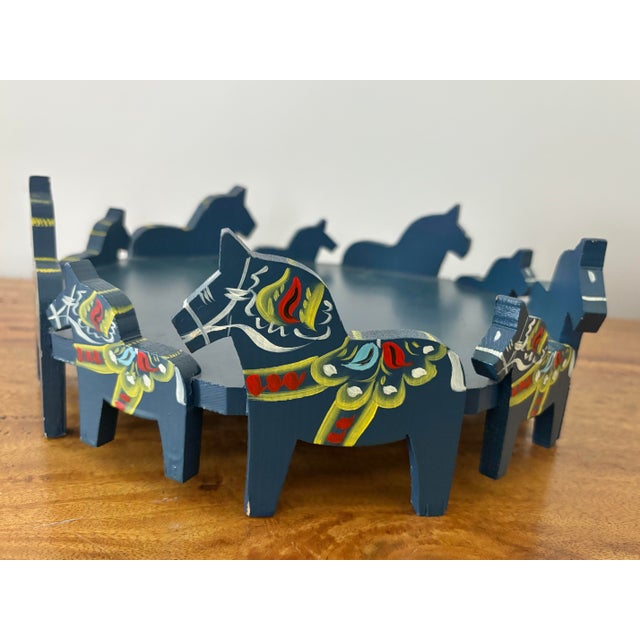 Vintage 1960's original Nils Olson wooden Dala Horse tray stand. Round tray has 10 hand-carved blue horses around the...