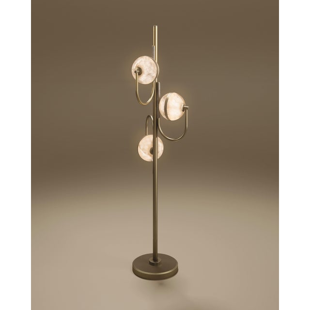 The Oculus Floor Lamp by Porus Studio is a sculptural floor lamp crafted in alabaster and aged brushed brass, inspired by...