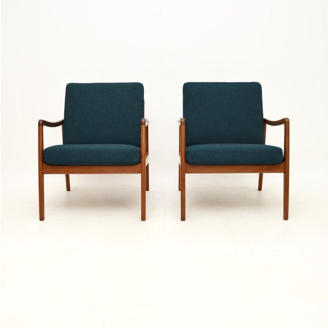 A stylish and extremely well made pair of Danish vintage teak armchairs by Ole Wanscher. They are model FD109 chairs made...