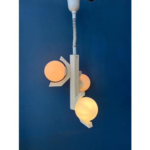 Gray bony design space age pendant lamp with three opaline glass shades. The frame is made out of wood and has a white...