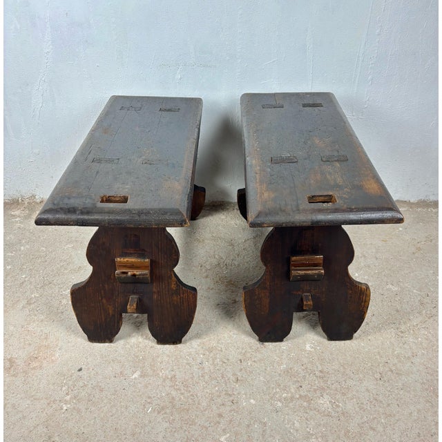 Charming pair of small rustic Spanish wooden stools featuring thick plank tops and sculptural cut-out supports. Crafted in...