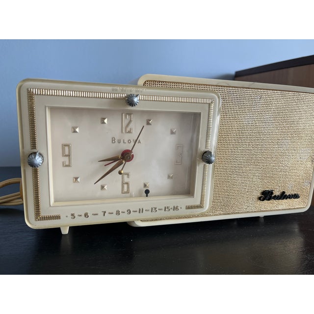 Vintage 1957 Bulova Tube Clock Radio Model 100 - Cream & Gold This tabletop vacuum tube AM radio was manufactured by...