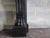 A 19th century (dated 1813) french black napoleon marble fireplace with panelled freeze and corner blocks on scrolled legs...