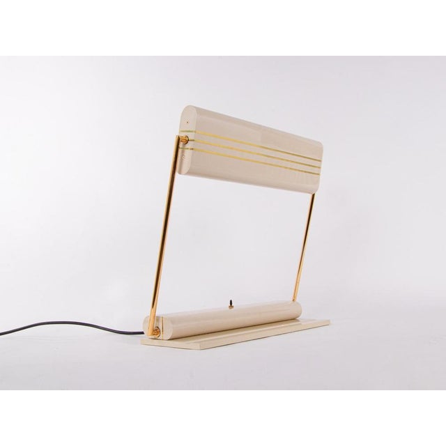 Elegant articulating art deco / streamline desk lamp made in europe in the 1930s. Beautiful ivory body with brass...