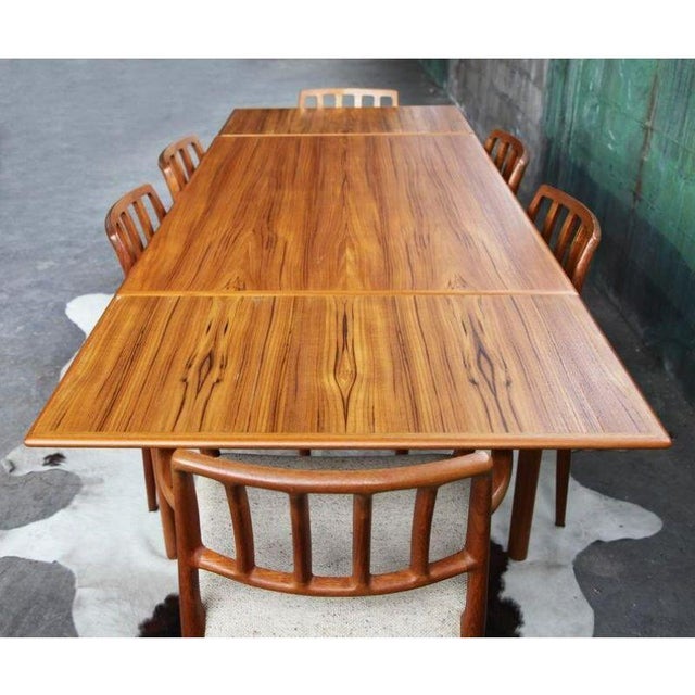 Beautiful large, extendable Danish Mid Century teak table with draw leaves that tuck under when not in use. The table is...