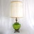 This pair of large vintage table lamps is styled in the Hollywood Regency aesthetic, featuring ribbed green Empoli glass...