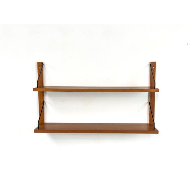 Modular "Cado Royal" shelving system in exquisite teak – a true Danish Modern design classic by Poul Cadovius. The set...