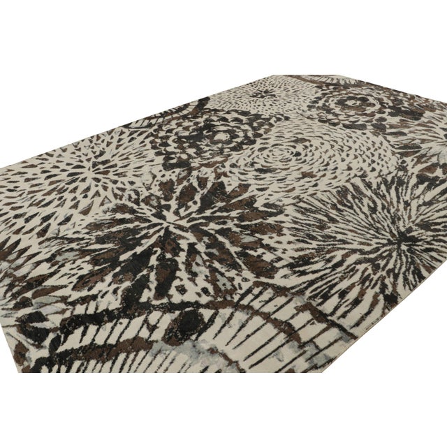 Hand-knotted in wool and silk, this 10x14 modern rug is inspired by one of the more mid-century modern French Deco styles...