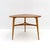 wonderful swedish wooden coffee table from the 1950s with teak veneer top, legs in birch with brass caps, great condition.