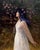 Westwind and Wildflower by Nanci France-Vaz | Oil Painting of a woman in a flowing dress with flowers For Sale