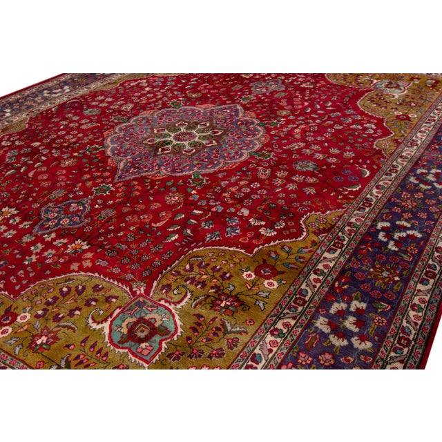 Beautiful Persian Isfahan hand-knotted natural wool rug with a red color field. This piece has a purple-designed frame...
