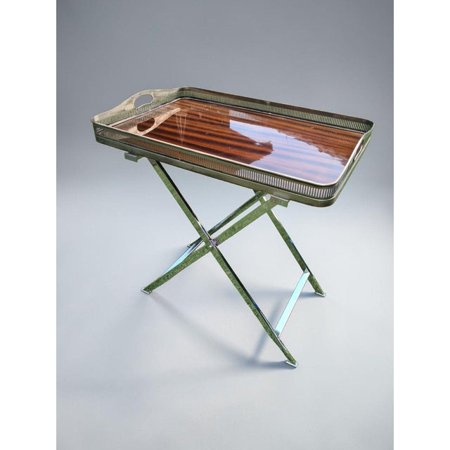 An elegant folding side table with a removable serving tray, designed in the Hollywood Regency and modern classic styles....