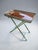 An elegant folding side table with a removable serving tray, designed in the Hollywood Regency and modern classic styles....