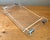 This vintage Lucite and chrome serving tray embodies the sleek sophistication of mid-century modern design, where...
