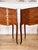 A pair of elegant french bedside tables in the louis xv style, made in the mid-20th century. Each has three serpentine...