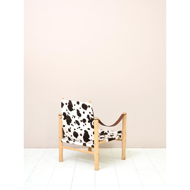 Safari chair by Elias Svedberg for Nordiska Kompaniet, with a light wood frame and cowhide-effect upholstery. Designed by...
