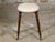 An English Victorian period oak stool from the 19th century with oval upholstered seat, turned legs resting on casters....