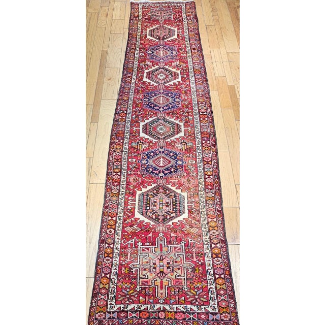 "A striking example of early 20th-century craftsmanship, this vintage Persian Heriz Karajeh runner was handwoven in the...