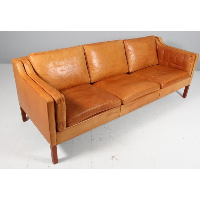 Børge Mogensen three-seat sofa with original patinated tan leather upholstery. Legs of teak. Model 2213, made by...