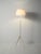 Scandinavian floor lamp from the 1950s/1960s in white-painted wood, featuring a slender tripod structure and a lampshade...