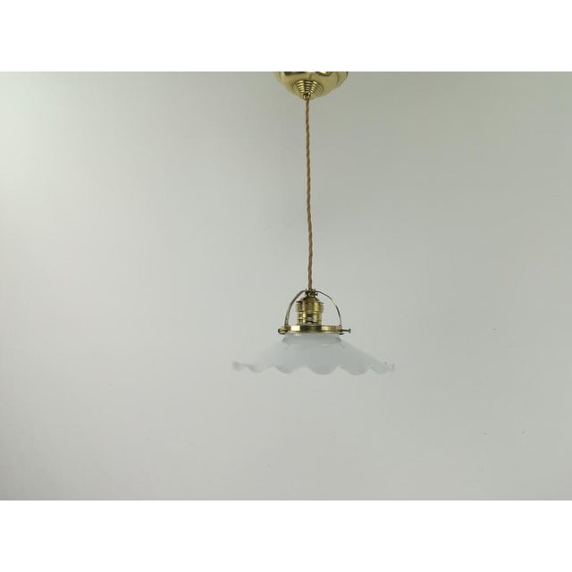 The old shade of this hanging lamp comes from France. Due to the simple, classic shape, is absolutely timeless. The opal...