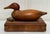 Various woods with exquisite grain throughout are consistent in this solid wood lidded wood box topped with a duck decoy....