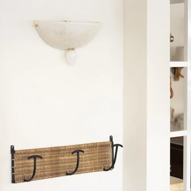 Beautiful blown glass sconce from Italy, 1980s. White glass semi-dome shaped sconce with glass teardrop and brass detail....