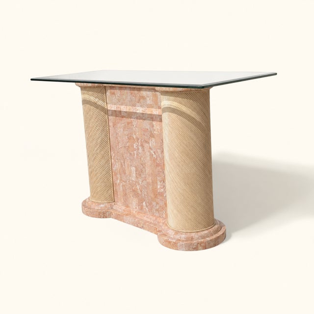 Postmodern console table from the 1980s with a rectangular glass top, tessellated stone base, and rounded textured column...