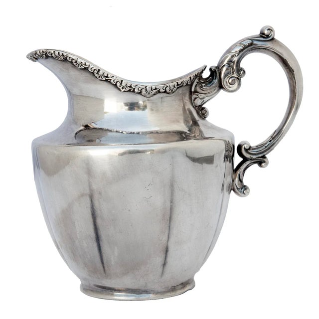 Antique Silverplate Monogrammed Pitcher with curvy flourishes & ornate trim around the rim.