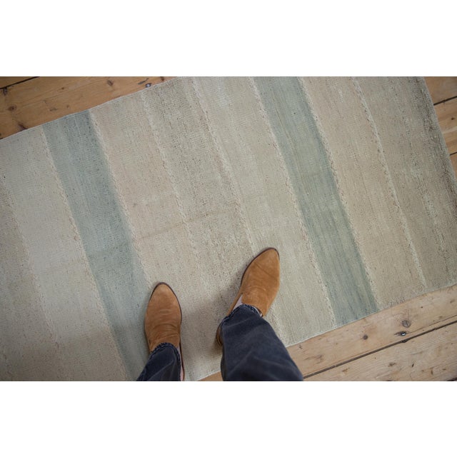 :: This flatwoven runner features a simplistic, balanced arrangement of evenly spaced vertical bands that create a subtle...