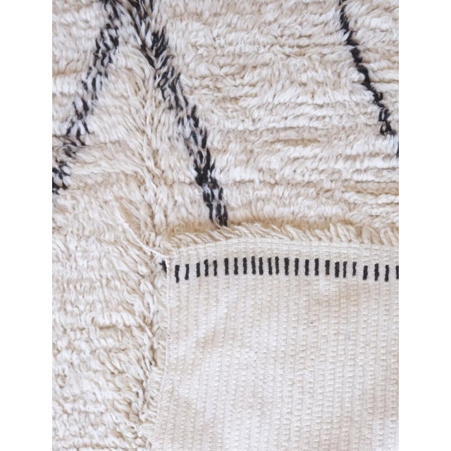 This Marmoucha Moroccan Wool Rug measures 7.2 by 5.2 feet (220 by 160 cm) and features a striking geometric design....