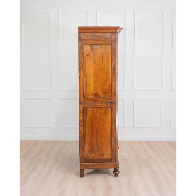 A refined Italian 19th century Louis Philippe wardrobe cabinet, crafted in richly figured walnut with a warm, luminous...