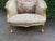 An elegant circa 1900 French Marquise loveseat, crafted from solid beechwood with a gilded gold finish, tufted beige...