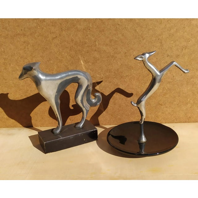 Small sculptures in chromed metal by Karl hagenauer. Not signed. No mark. Greyhound with marble base, fawn with black...