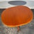 This oval extendable dining table is a refined example of British mid-century teak furniture from the 1960s, featuring an...