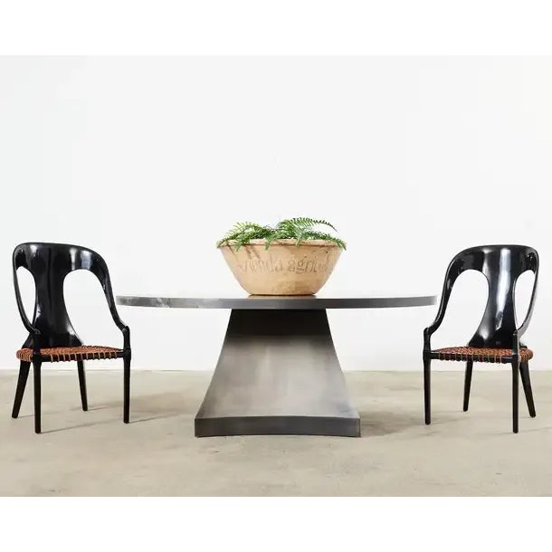 Imposing minimalist round iron dining table or grand center table designed by Sally Sirkin Lewis for J. Robert Scott. The...