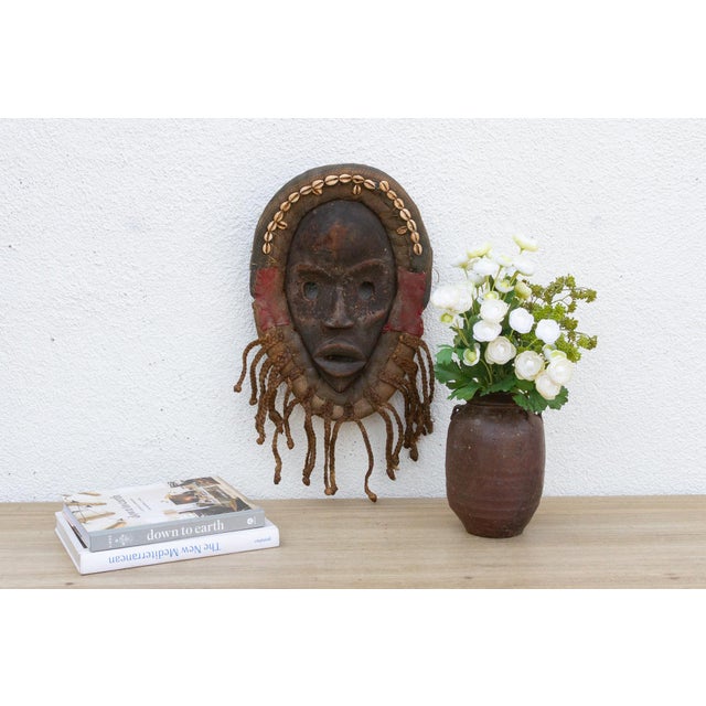 This enigmatic Dan mask from the Ivory Coast is a captivating example of African tribal art. The mask is characterized by...