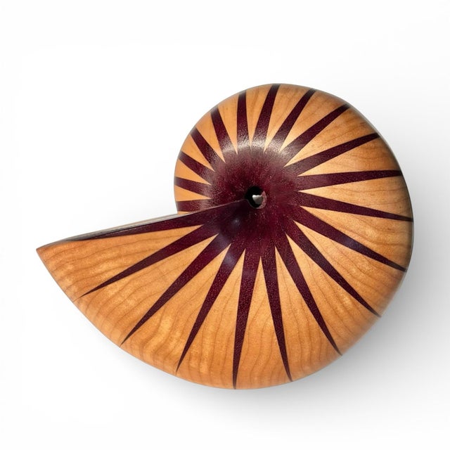 A stunning turned wood nautilus shell sculpture made from maple and purpleheart. Signed and dated on the interior