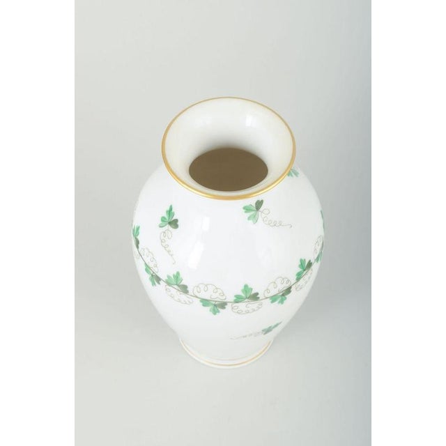 Herend, Hungary Vase, mid-20th century. Elegant porcelain vase with hand-painted green leaf decoration and fine gilt...