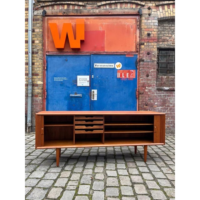 This elegant teak sideboard, designed in the 1960s by Svend Aage Larsen for Faarup Møbelfabrik, is an outstanding example...