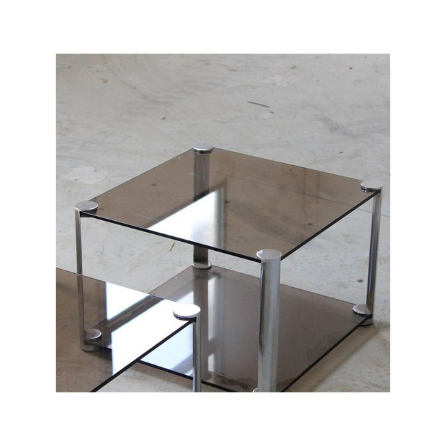Type Tris coffee tables (set of 3) Date 1960 Origin Italy Materials Smoked glass, Steel Designer A. Ari Colombo...