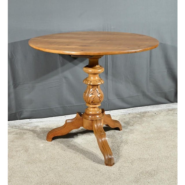 Cherry wood pedestal table with a warm color and a glossy finish highlighting its antique character. Recognized for its...